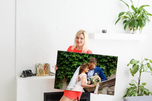 Woman holding wedding photography photo canvas print with gallery wrap.