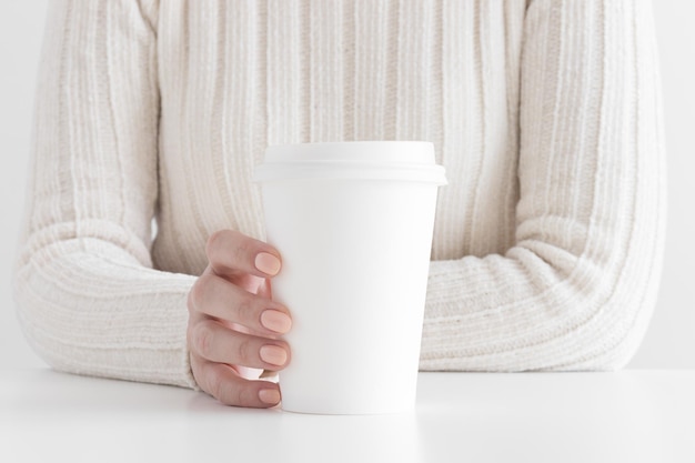 Woman holding white coffee paper cup mockup