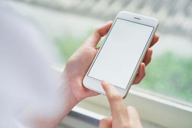 Woman holding a white phone with a blank screen