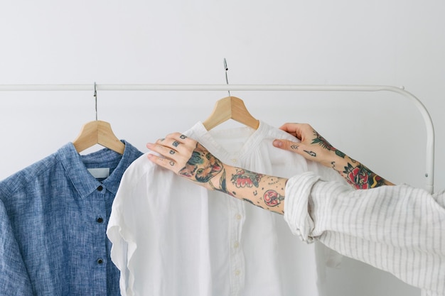 Woman holding a white shirt on a rack