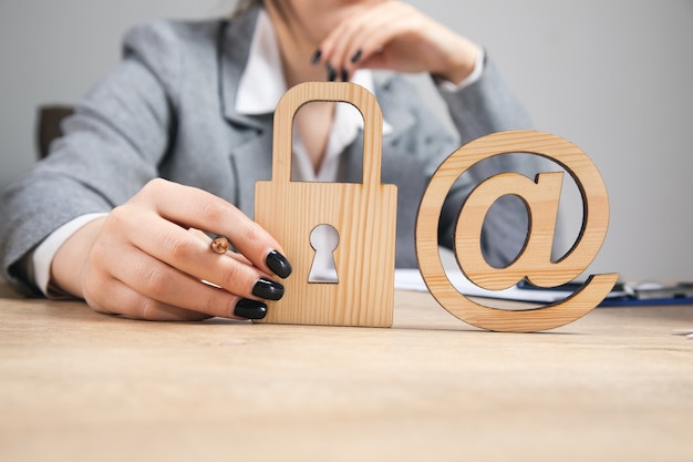 Woman holding wooden lock and mail sign