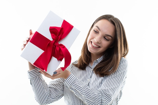 Woman holding a wrapped gift box with ribbon isolated