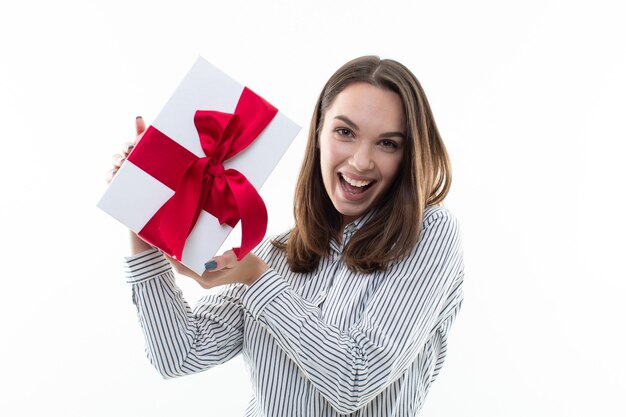 Woman holding a wrapped gift box with ribbon isolated