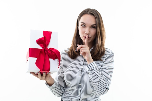 Woman holding a wrapped gift box with ribbon isolated