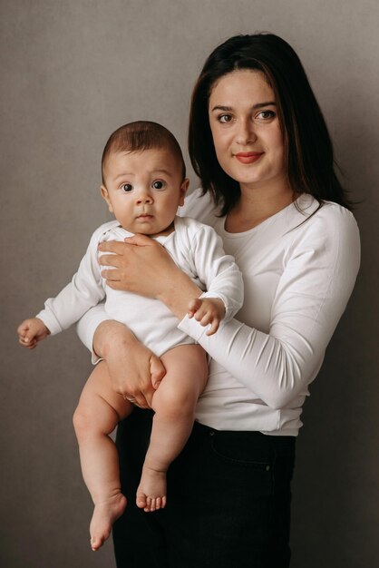 A woman holds a baby in her arms.