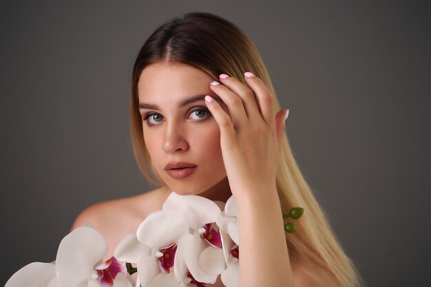 Woman holds beauty flower skin care treatment