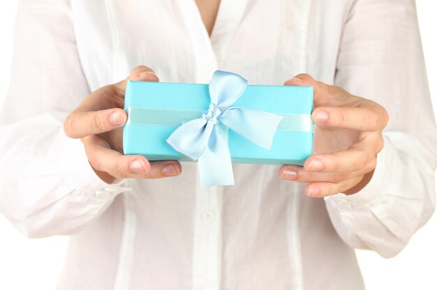 Woman holds a box with a gift on white background close-up