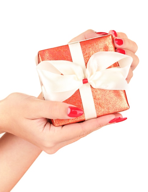 Woman holds  box with gift on white surface close-up