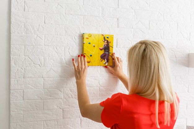 woman holds canvas at home