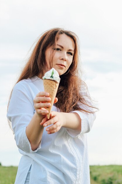 A woman holds a cone with popsicles in her hands. Cool dessert in summer.