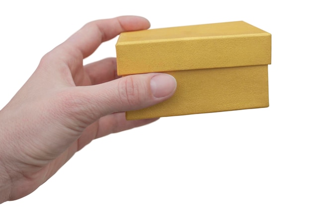 A woman holds a golden gift box in her hands on a white background The concept of holidays gifts