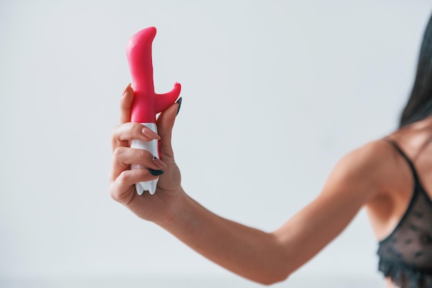 Photo woman holds pink masturbator in hands. conception of intimacy.