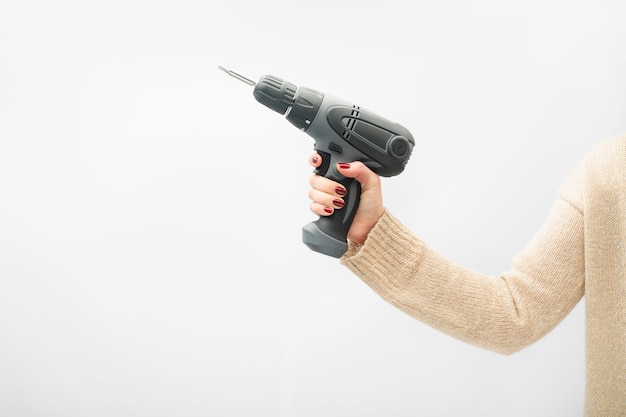 Woman holds screwdriver drill