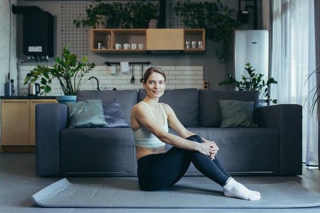 Woman at home doing morning exercises doing fitness