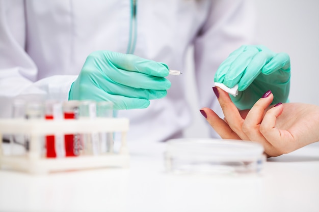 Woman at the hospital submits a blood test for a coronavirus