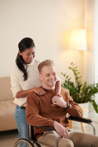 Woman Hugging Boyfriend in Wheelchair