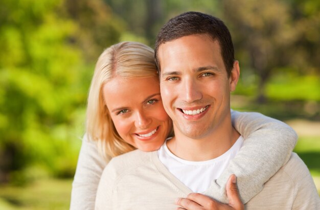 Woman hugging her boyfriend in the park