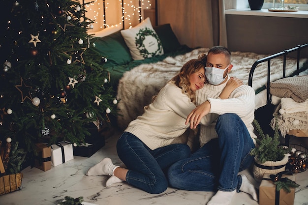 Woman hugging man in face mask.