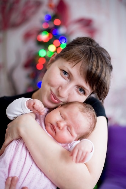 woman hugging a sleeping baby