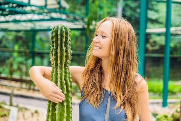A woman hugs a cactus as her best friend. Problems of friendship concept.