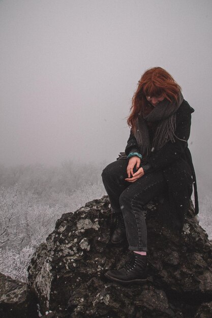 Фото Женщина в снежной земле во время туманной погоды