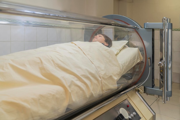 Woman inside a hyperbaric treatment machine