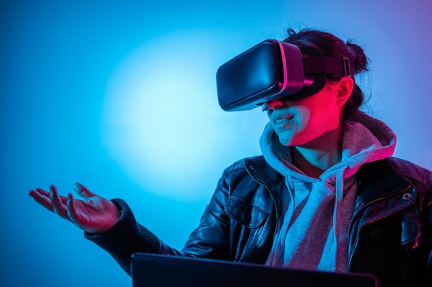 Woman interacting in metaverse with virtual reality goggles