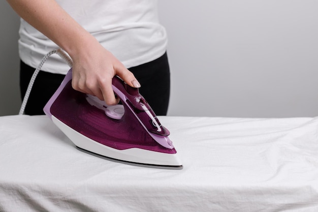 Woman ironing close-up with iron