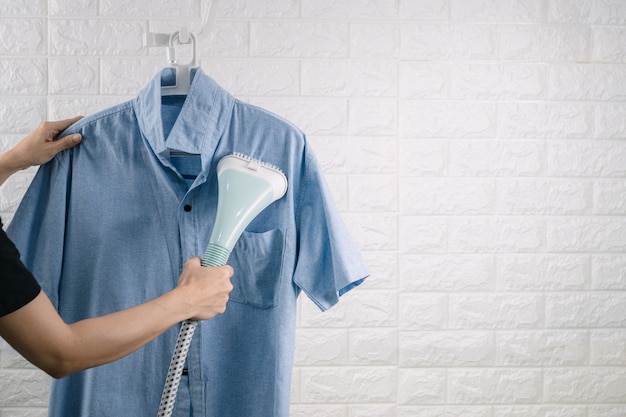 A woman ironing clothes with Steam iron