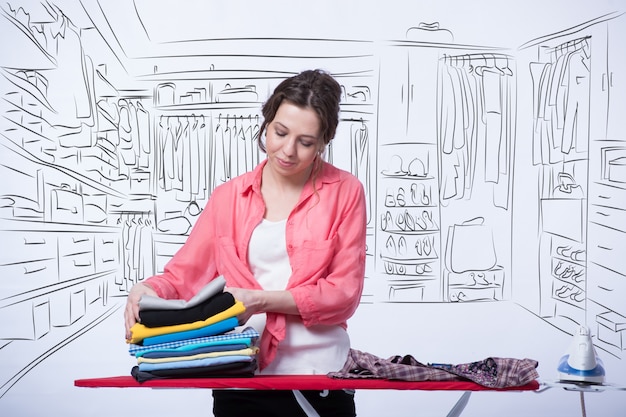 Woman ironing clothing in her room