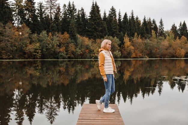 The woman is in the autumn park Autumn atmosphere scenic view of the river