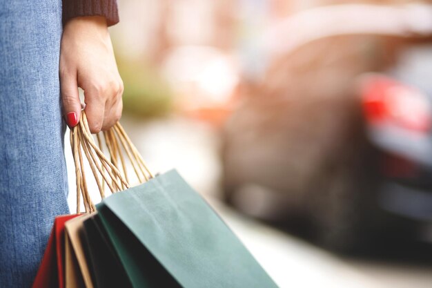 Woman is carrying shopping bags at the mall