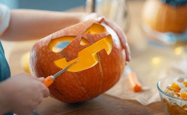 Woman is carving pumpkin