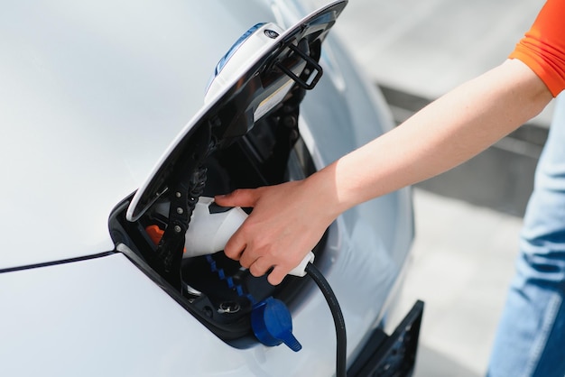 Woman is charging rental electric car