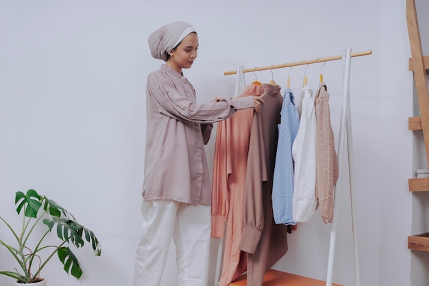 a woman is choosing clothes