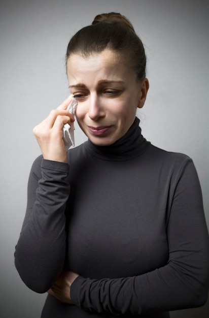 The woman is crying. Grief, misfortune, tragedy.