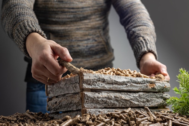 A woman is cutting wood with a knife.