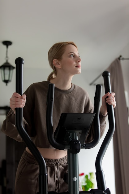 Woman is doing workout in the orbitrack at home