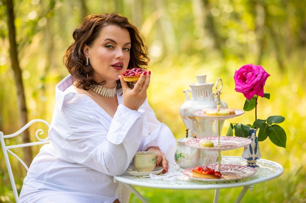 Woman is drinking coffee in the morning on the nature