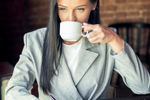 Woman is drinking coffee