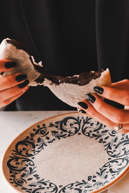 a woman is eating a piece of chocolate cake