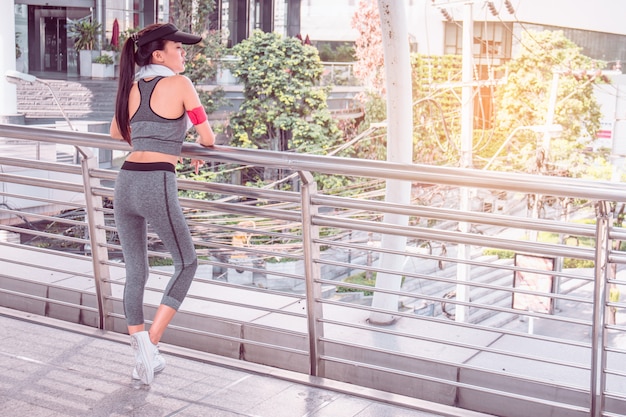 Woman is exercising in the city