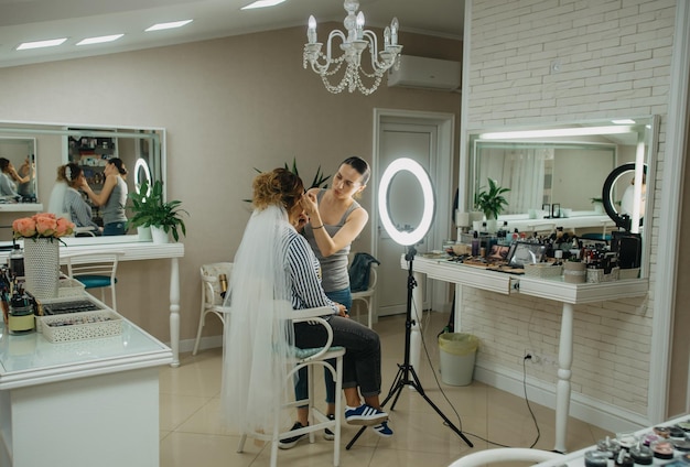 A woman is getting her makeup done in a beauty salon.