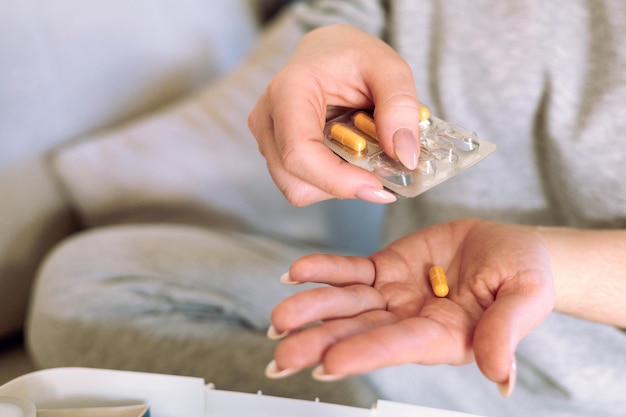 woman is going to take medicine for headache stomach or vitamin and food supplements