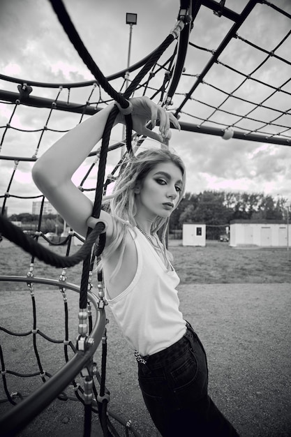 Photo a woman is hanging on a net with the word 