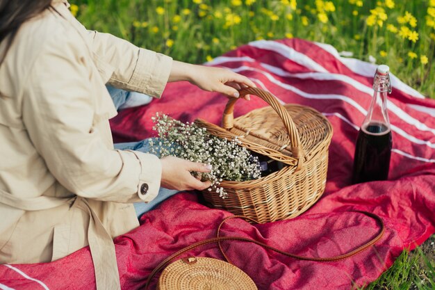 woman is holding basket with white flowers