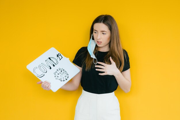 woman is holding a board with an inscription -19