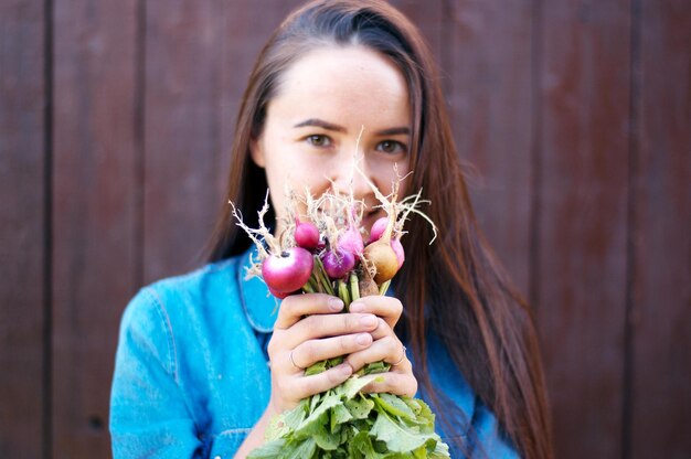 Woman is holding fresh radish