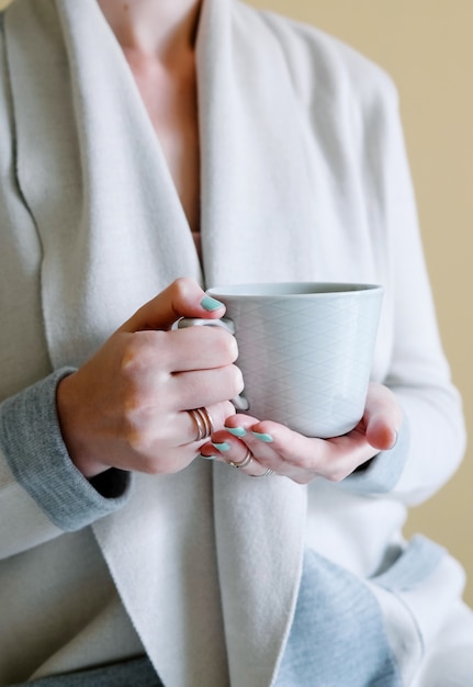 Woman is holding hot tea