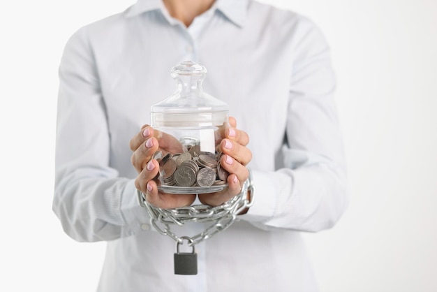 Woman is holding jar of piggy bank with coins with hands tied criminal financial crimes concept